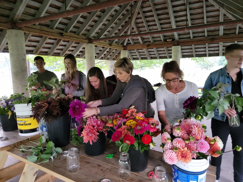 Participants in the NEPA Creative Meetup select flowers for their mason jar arrangements at Kirby Park on September 21.