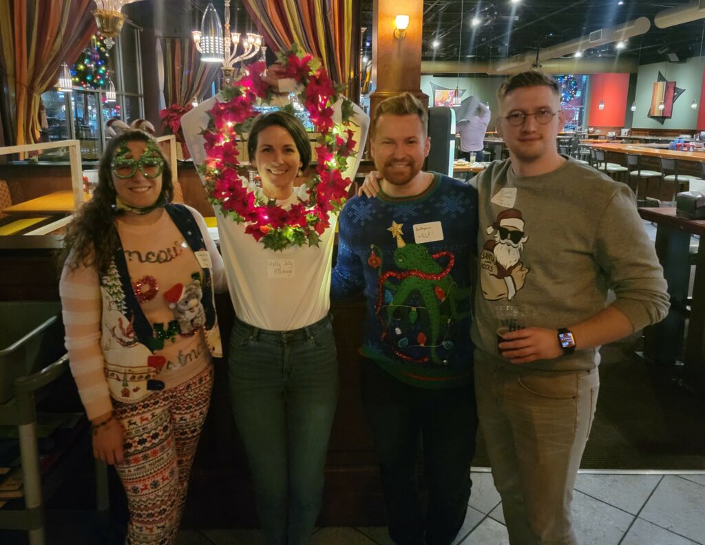 Holly K. Pilcavage, second from left, shows off her wreath-inspired outfit for the Greater Wyoming Valley Chamber’s Ugly Christmas Sweater Holiday Party.
