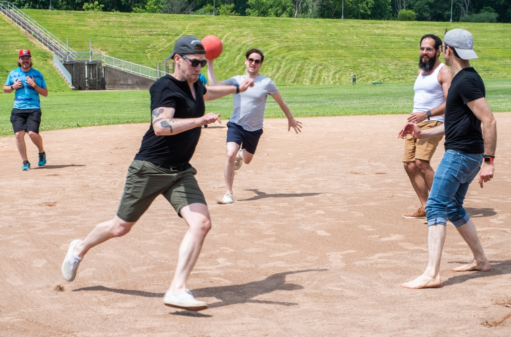 Sam O'Connell outruns a throw. from Will McHale during a close kickball game at Coal Creative Team Building Day.